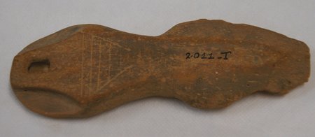 Waisted ceramic blade with a perforated end and incised lines, marked 2011-I.