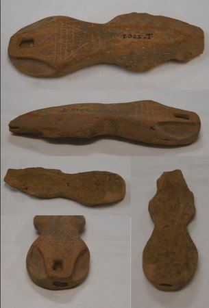 Five views of the same ceramic blade, showing both faces, the edges and the perforated end.