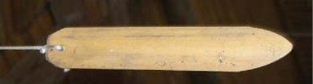Cheng's photograph of the Tsou euvuvu: a leaf-shaped bamboo slat, rounded at the corded end and tapering to a blunt point at the other.