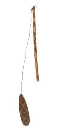 Roro blade incised with three white-filled crosses, hung by a fine cord from its fire-decorated stick.
