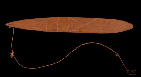 Its small companion, catalogued as a child’s toy, engraved with red-filled zigzags and crossed lines.