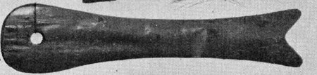 Dark baleen blade shaped like a whale, with a forked tail at right and a round hole near the broad rounded head at left.