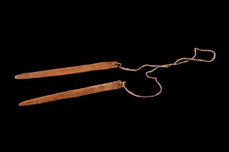 A Zuni two-slat form: twin blades joined by a hide thong, collected by James Stevenson before 1883.