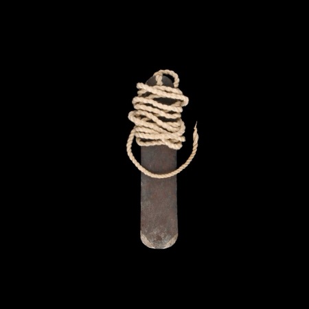 A smith-forged iron blade from Sanga, its cotton cord wound about its head.