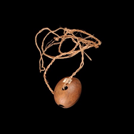 Its mate 71.1936.40.52, the cord threaded through the seed's eye.