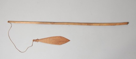 A long slender stick strung at one end with a small diamond-shaped wooden blade — a Kenyah/Klemantan child's bull-roarer from the Baram River,...