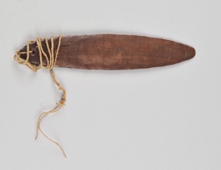 A plain dark leaf-shaped wooden lath, unmarked apart from a long split, with plant-fibre cord wound in several turns through a hole at its...