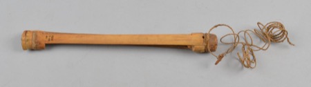 A slender tapering wooden rod bound with cord near one end, more spindle than blade in shape: an African bullroarer of the general type, not...