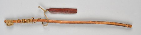 A complete whirling rig collected in Nigeria around 1900 and attributed to the Yoruba: a reddish bevel-edged blade strung by its cord to the...