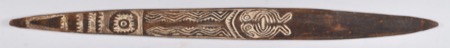 A New Guinea bull-roarer painted with white chevron bands, a dotted circular motif, and a toothed face near its tip; no photograph of the Ruk...