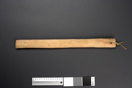 A plain, pale wooden board with a cord knotted through a hole near one end - another of the Oslo museum's Hopi bullroarers, standing in for the...