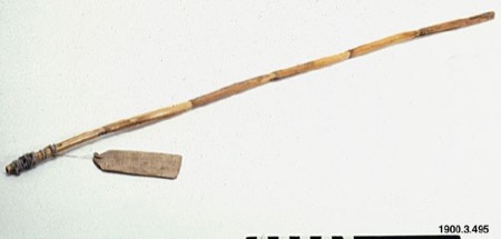 A Pipil bull-roarer — a slender cane rod with a wooden identification tag tied near the handle; no image of the Oro-derived Afro-Cuban...
