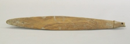 An Iatmul bull-roarer from the Middle Sepik, a plain weathered blade with a small notched tang pierced for the cord at one end; a...