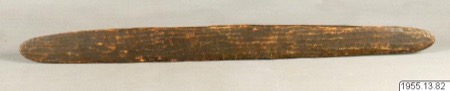 An Aboriginal Australian bullroarer of dark, mottled wood with a lightly incised surface, tapering to points at both ends - a Stockholm museum...