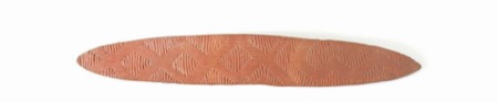 A wooden board carved in the same diamond chevron style — shown for the general type; the Ungarinyin and Worora bull-roarers named in the Elkin...
