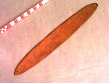 A plain elongated wooden bull-roarer blade from the Wereldmuseum's Aboriginal Australian collection; the Lardil instrument of Mornington Island...