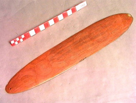 A wooden board incised with a line of concentric circles down its length — shown for the general Aboriginal Australian type; no further...