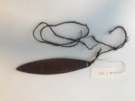 I.7291 on its black hair cord, faint arcs incised down the blade.