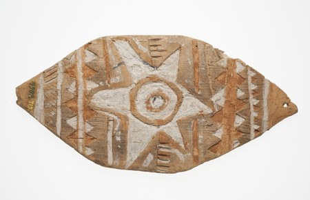 A broad, leaf-shaped wooden bullroarer, smooth-edged, its face painted with a white star around a ringed central eye and flanked by columns of...