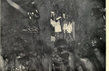 Inside the Antelope kiva at Mishongnovi during the Snake-Antelope ceremony, a Kalehtaka at right whirls the bullroarer.