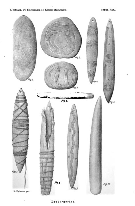 A plate of incised wooden churinga and bull-roarers of Central Australia, engraved with concentric-circle and meander designs.