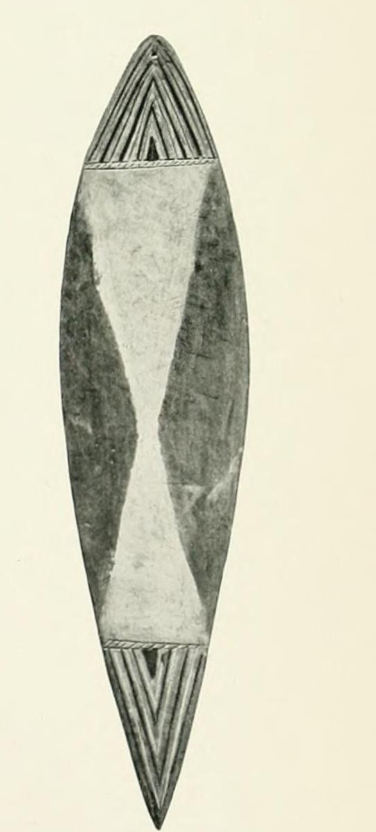 Haddon's photograph of a leaf-shaped Mer bigu bullroarer with chevron-carved ends.