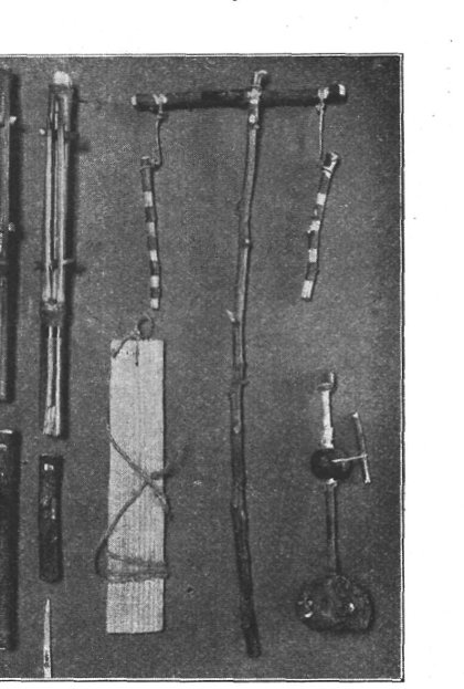 Torzsa's homemade toy chest, photographed in 1906: the zúgó (Windbrummer) is the pale slat at centre with its cord still tied through the...