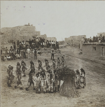 Snake priests gather around the kisi at Walpi in 1905. The bullroarer is not visible in this stereograph.