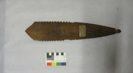 A double-pointed wood blade notched along both edges, with a small hole pierced near its tail — shown for the general type; the single Indian...