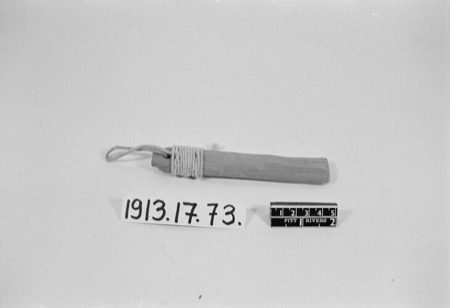 An Arab bull-roarer, a short wood board with a ribbed, fluted face, cord wound and looped at its handle end; the Kipsigis swung a small wooden...