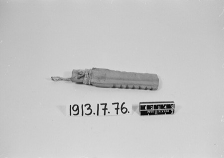 A ridged, notch-edged wooden bull-roarer bound with cord, labelled an Arab piece — shown for the general form; the Andebogo's kundrukundru,...