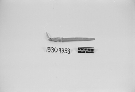 A narrow flat wooden blade with cord bound near its squared end — a Yoruba bull-roarer held by the Pitt Rivers Museum, shown for the general...