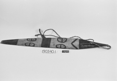 A board painted with paired semicircle motifs in two pale panels set between solid dark bands, a chevron near the tail, photographed in black...