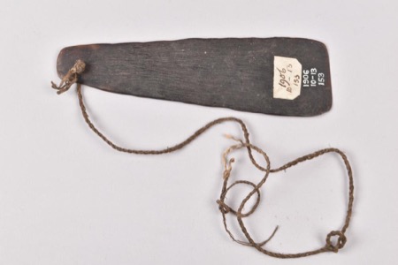 Masingara turtleshell bullroarer Oc1906,1013.153, with its twisted plant-fibre cord; British Museum.