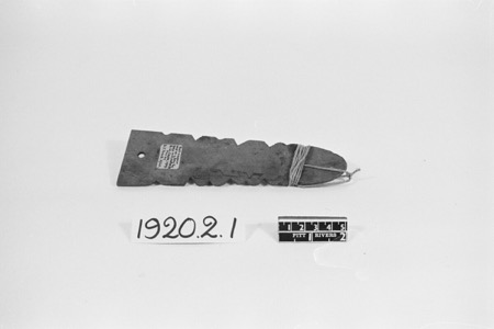 Clanfield serrated bullroarer with its cord wound around the tapered end, Pitt Rivers Museum 1920.2.1.