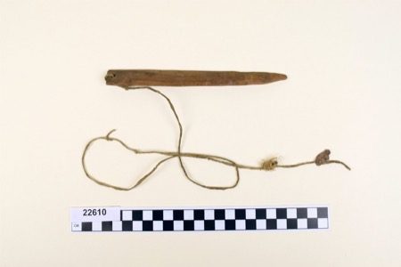 Zuni bullroarer 22610, c. 1900, with terminal hole and buckskin/cotton string; Penn Museum.