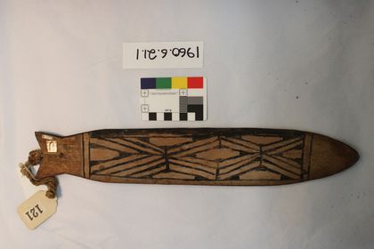 Kamaiurá fish-form blade with a forked tail at the cord end, painted with black zigzag lattice (PRM 1960.6.21.1).