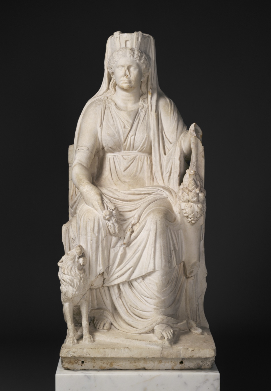 Roman marble statue of Cybele enthroned, wearing a mural crown, with the portrait head of her priestess